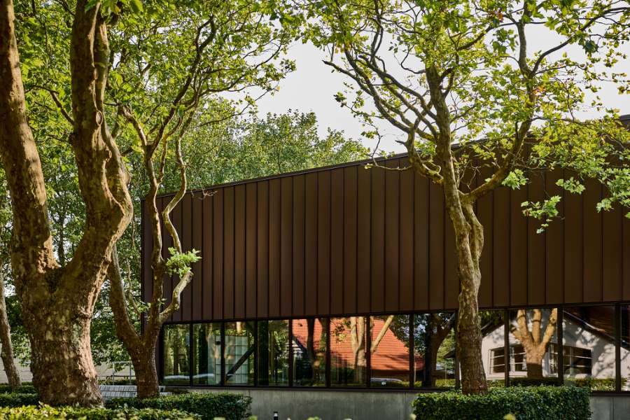 New sports hall in the “forest” wrapped in acorn-brown steel profiles, Risskov Efterskole, Tretommervej 31A, 8240 Risskov, Denmark